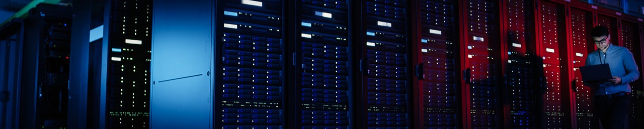 A man working on his laptop in the data center room