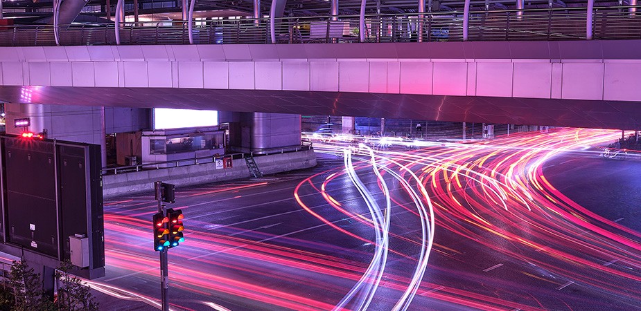 Line of streaking car lights moving through streets