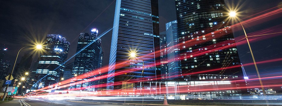View looking up at Singapore skyscrapers at night