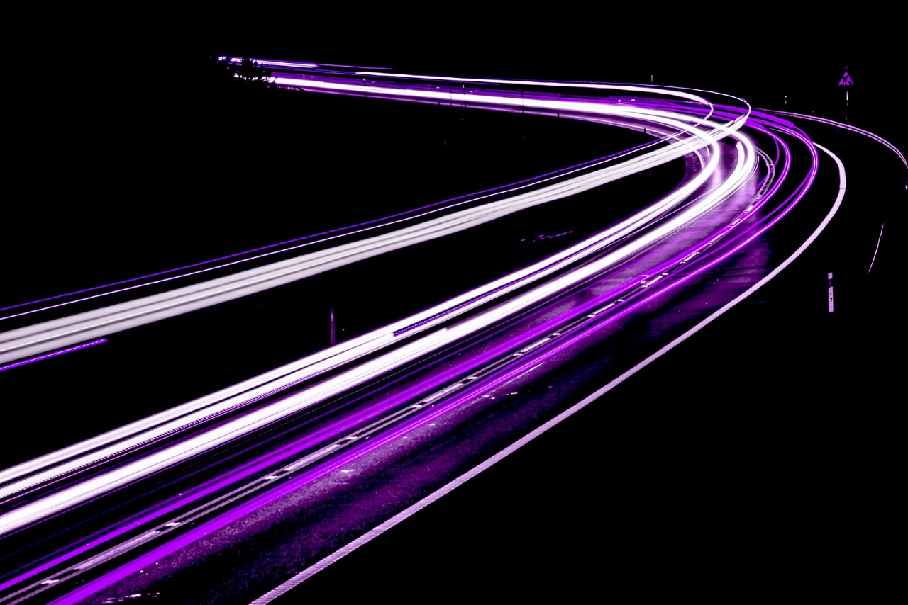 Image of highway with traffic and beaming lights